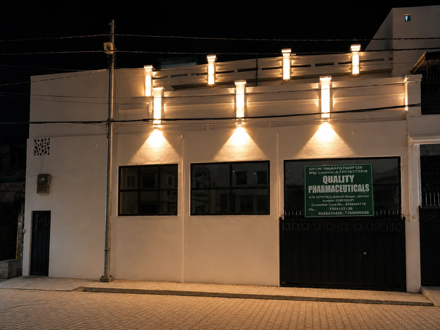 Quality Pharmaceuticals premises illuminated at night
